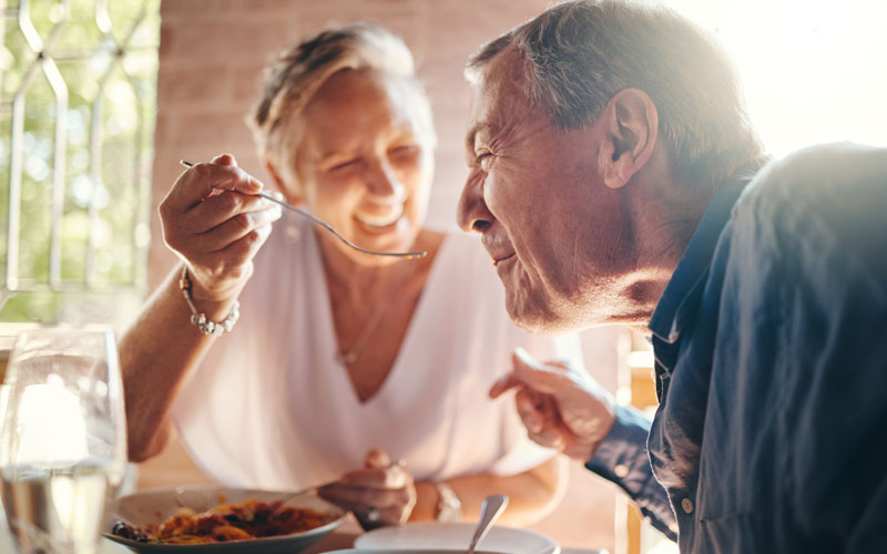 seniors-dining Elderly couple enjoying a meal together in a communal dining area.