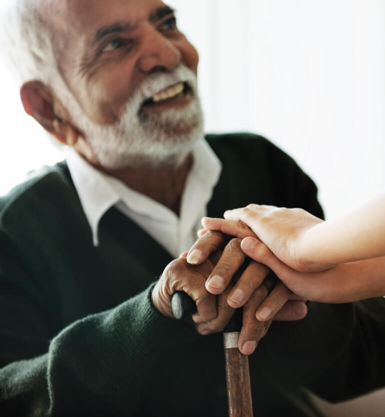 senior man resting his hands onto his cane