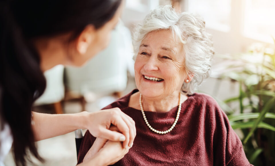 Senior woman holding the hand of an employee