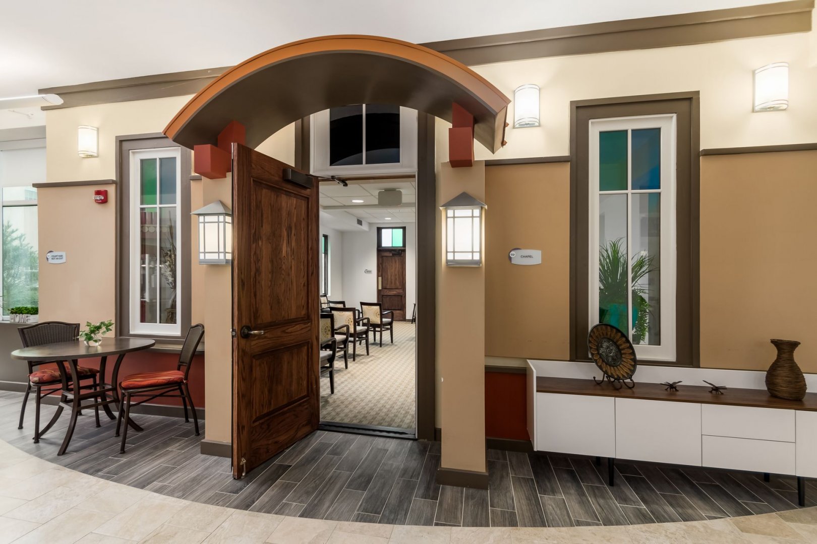 Common Area and Chapel Entrance in a Senior Living Community Interior view of a common area in a senior living community with a doorway leading to a chapel.