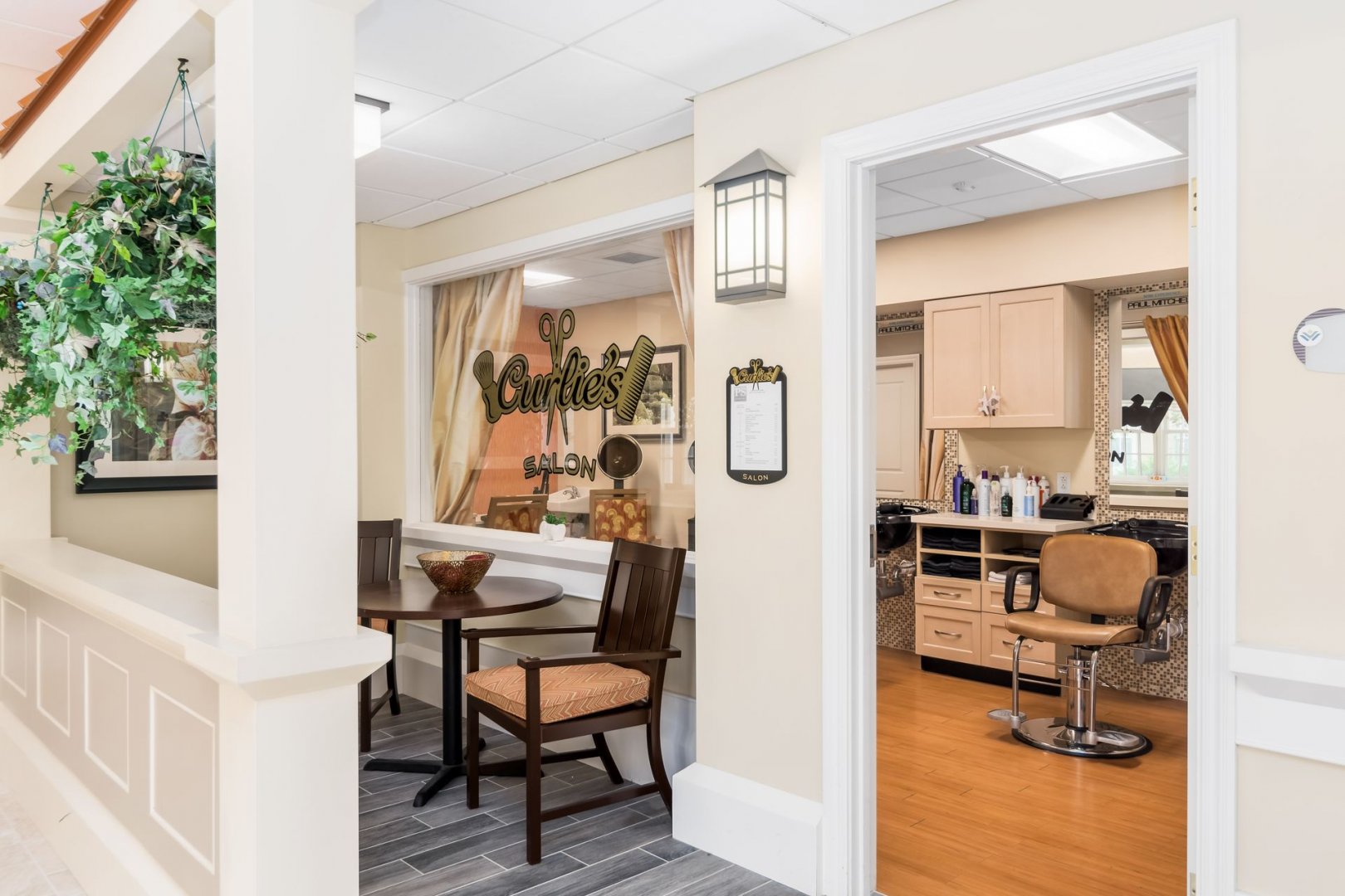 Community Salon Area Interior view of a senior living community salon area with a seating table and hair styling chair.