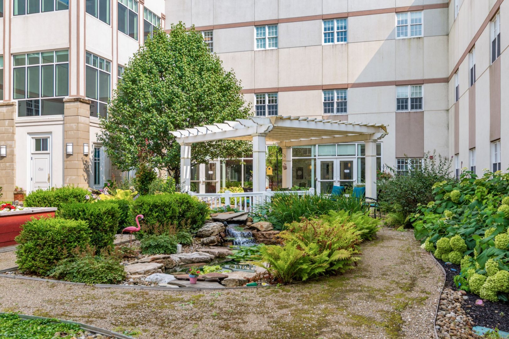 Courtyard Garden in Senior Living Community, New Albany, OH Outdoor courtyard of a senior living community with garden, waterfall, and seating area.