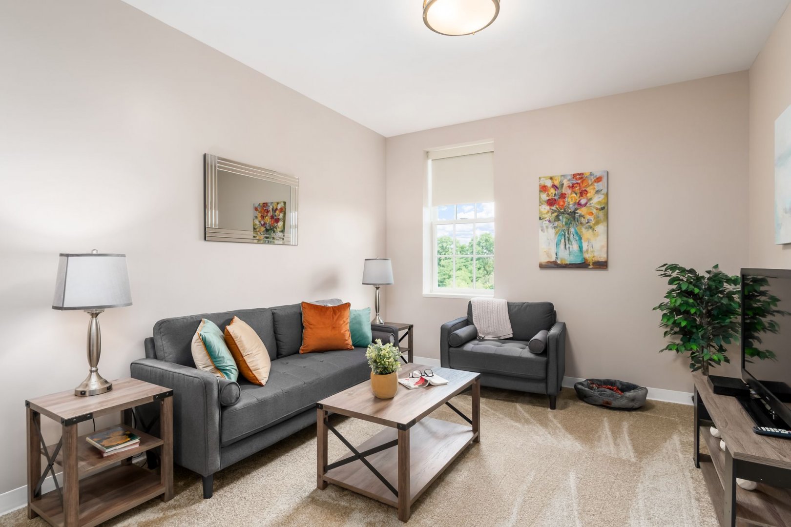Cozy Living Room in New Albany, OH A cozy living room with modern decor, featuring a sofa, armchair, coffee table, and wall art.