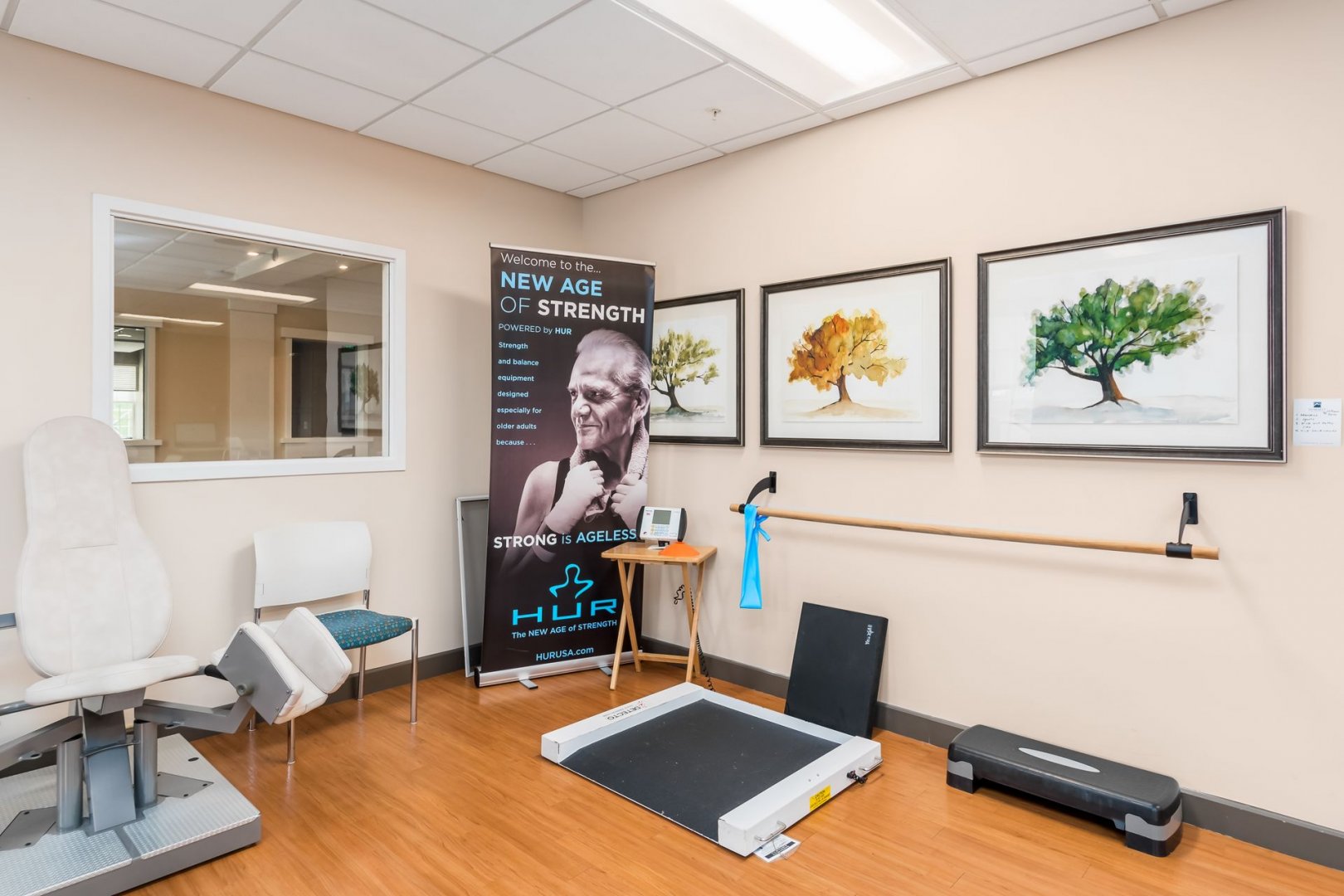 Fitness and Physical Therapy Room at New Albany Living Units Physical therapy room with exercise equipment and motivational poster in a senior living community.