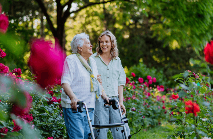 walking-through-gardens (1) senior woman walking through flower garden